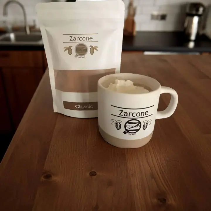Zarcone Cocoa package and mug on a wooden surface with kitchen background
