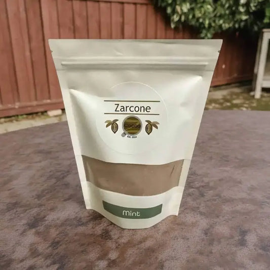 Zarcone mint product packaging on a stone surface with a blurred outdoor background