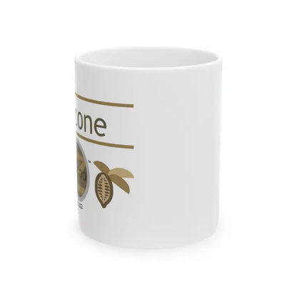 White mug with gold text and cocoa bean illustration on a white background